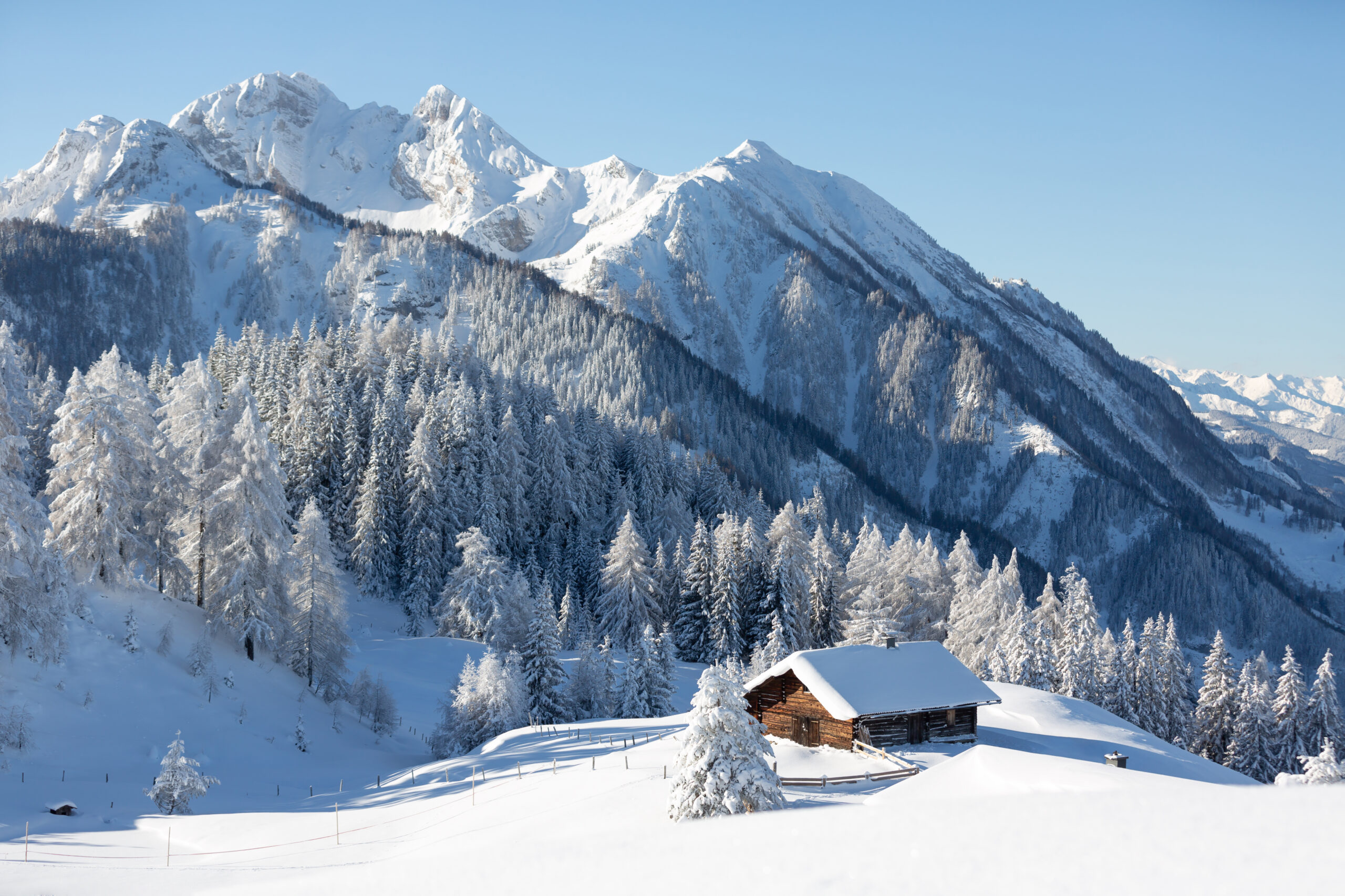 Winter wonderland in Alps. Picturesque winter scene with small chalet.