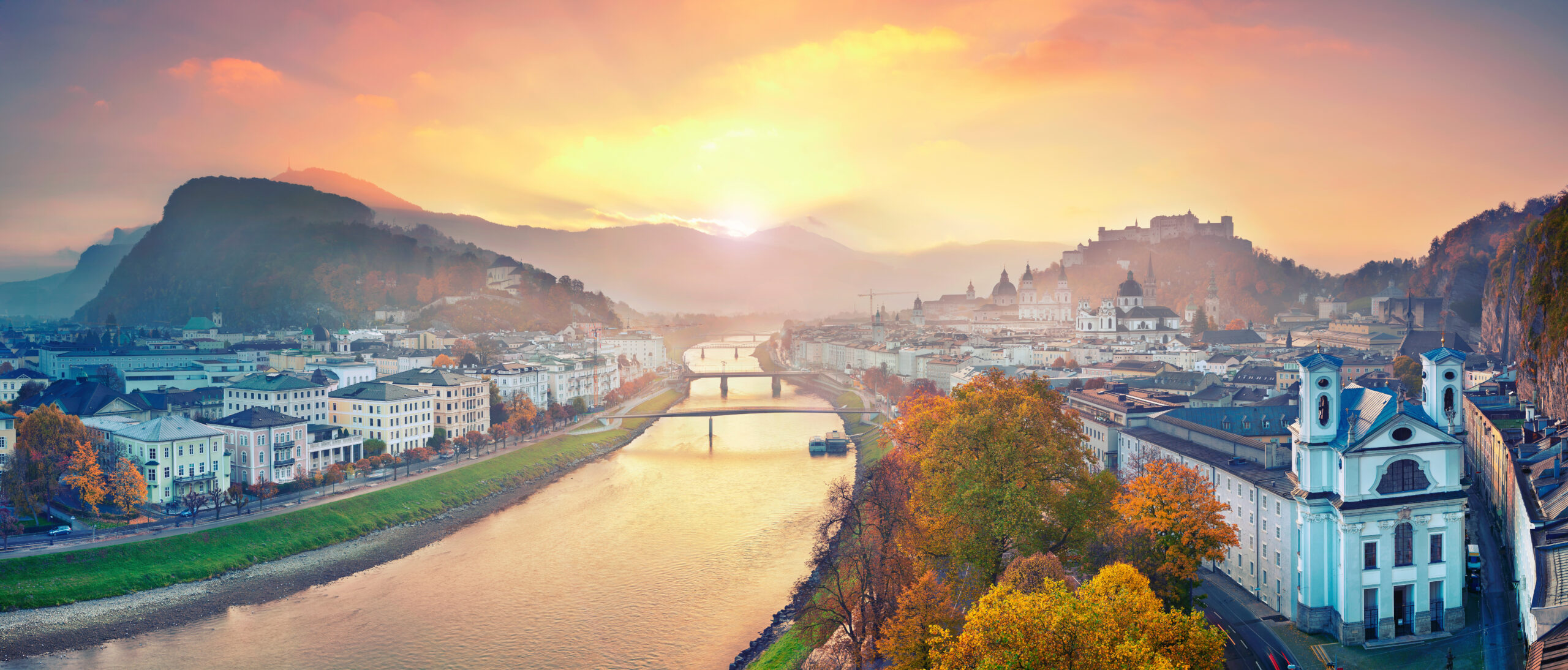 Panoramic image of town along river during autumn.